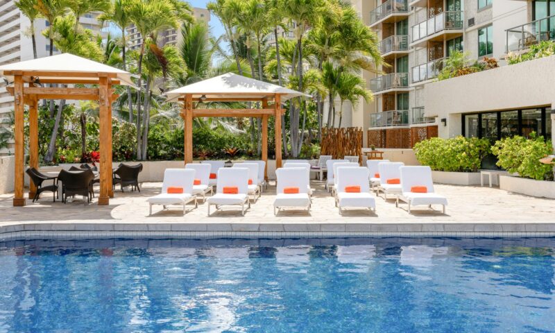 Large pool with lounge chairs at Luana Waikiki